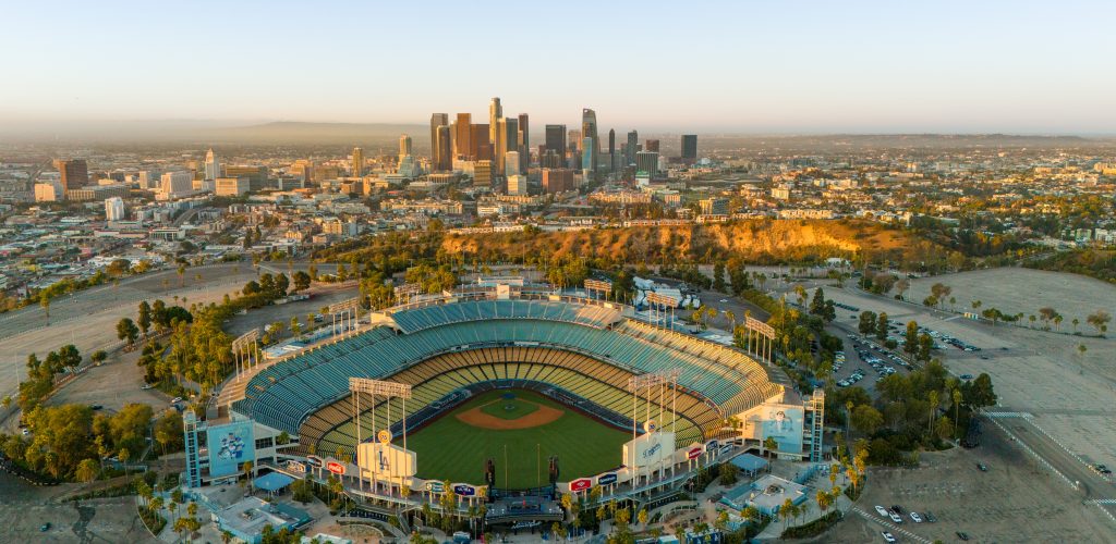 Los Angeles, USA - October 29th 2024: the Dodger Stadium with the skyline of downtown Los Angeles at dawn. Aerial view, clear sky.