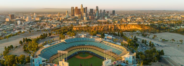 Los Angeles, USA - October 29th 2024: the Dodger Stadium with the skyline of downtown Los Angeles at dawn. Aerial view, clear sky.