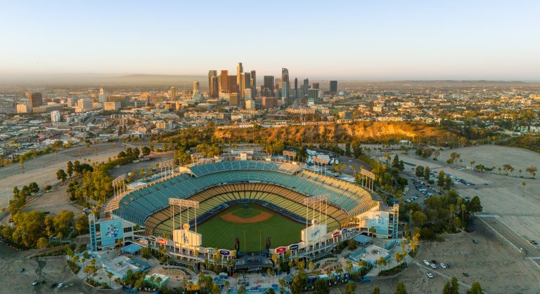 Los Angeles, USA - October 29th 2024: the Dodger Stadium with the skyline of downtown Los Angeles at dawn. Aerial view, clear sky.