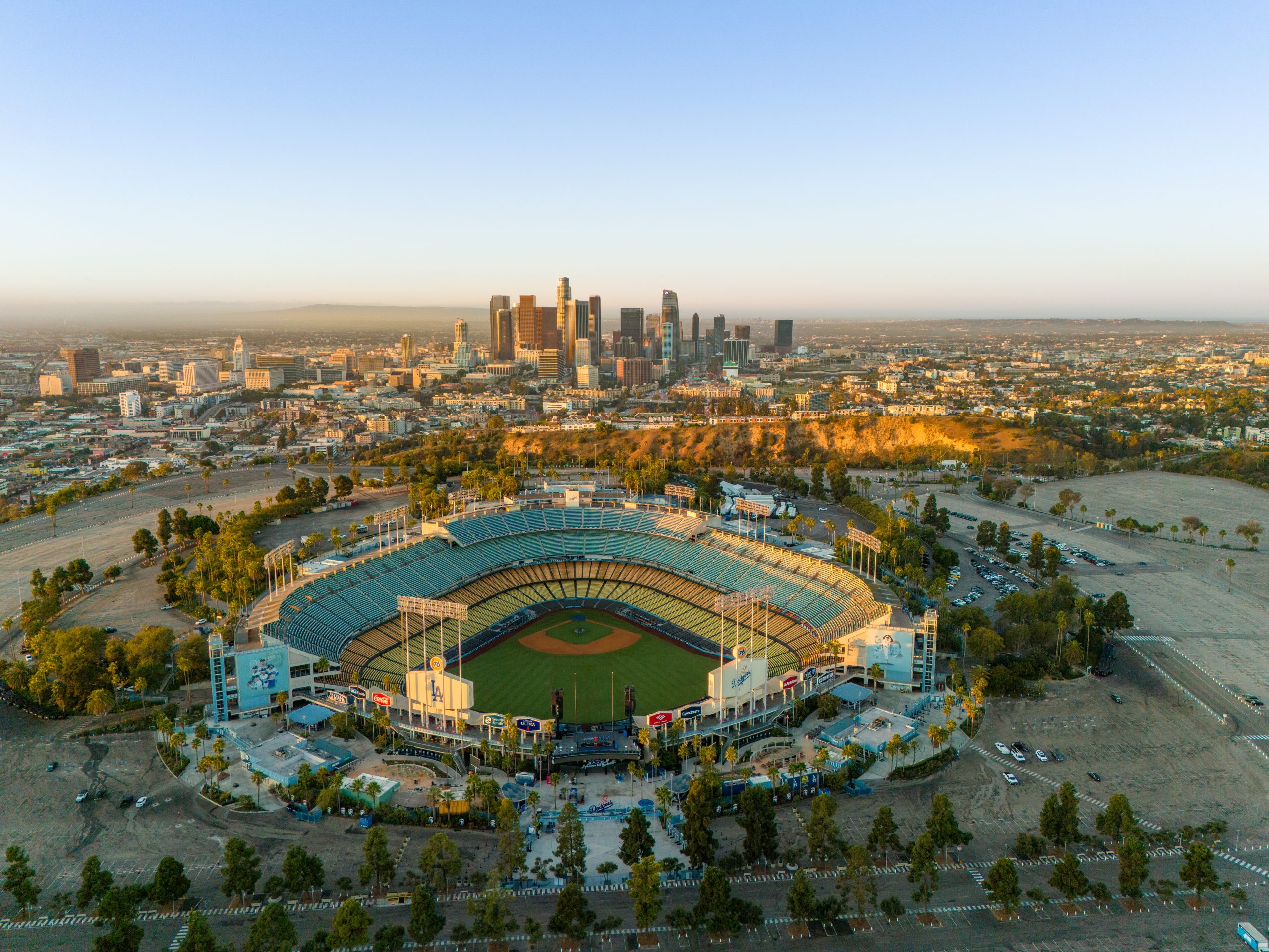 Los Angeles, USA - October 29th 2024: the Dodger Stadium with the skyline of downtown Los Angeles at dawn. Aerial view, clear sky.