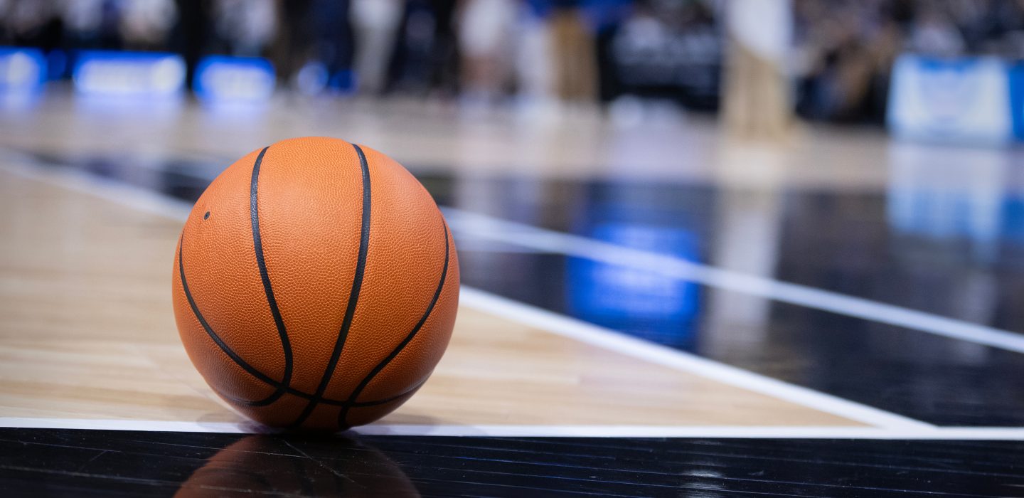 Basketball resting on a court during a big championship game. Copy space and great basketball concept photo