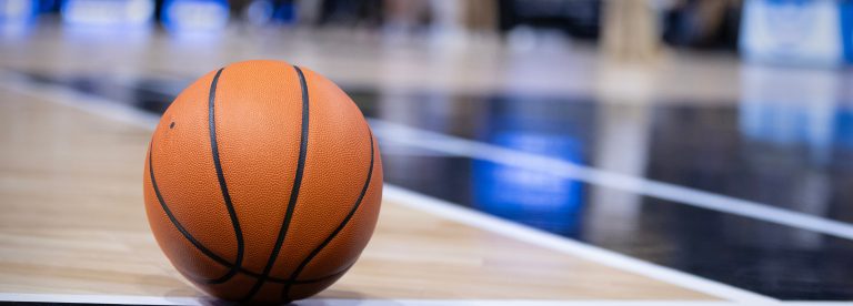Basketball resting on a court during a big championship game. Copy space and great basketball concept photo