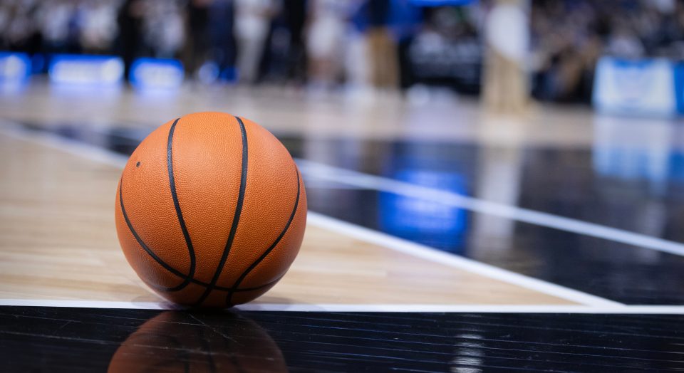 Basketball resting on a court during a big championship game. Copy space and great basketball concept photo