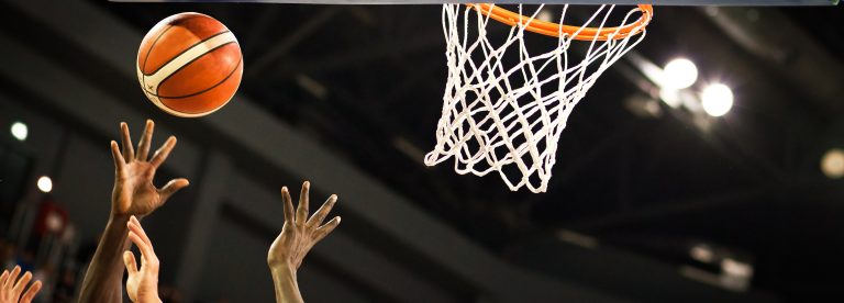 scoring during a basketball game - ball in hoop