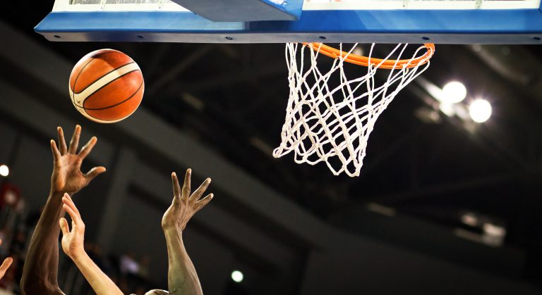 scoring during a basketball game - ball in hoop