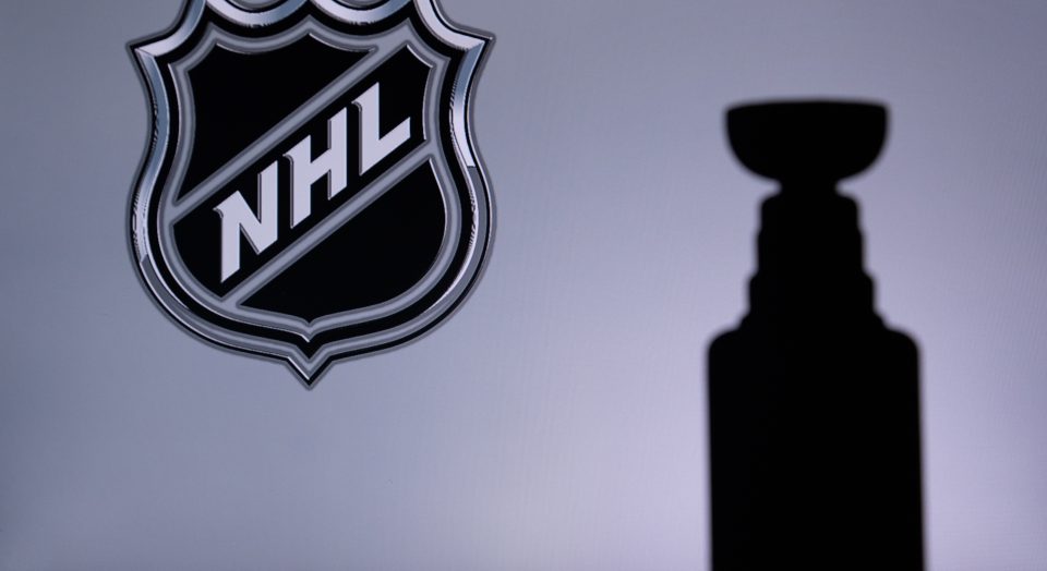 TORONTO, CANADA, 17. JULY: National Hockey LeagueLogo of NHL club on the screen. Stenley Cup Trophy Silhouette.