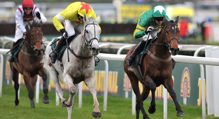 Neptune Collonges ridden by Daryl Jacob (left) races against Sunnyhillboy ridden by Richie McLernon prior to winning the John Smith's Grand National Chase during Grand National Day at Aintree Racecourse, Liverpool.