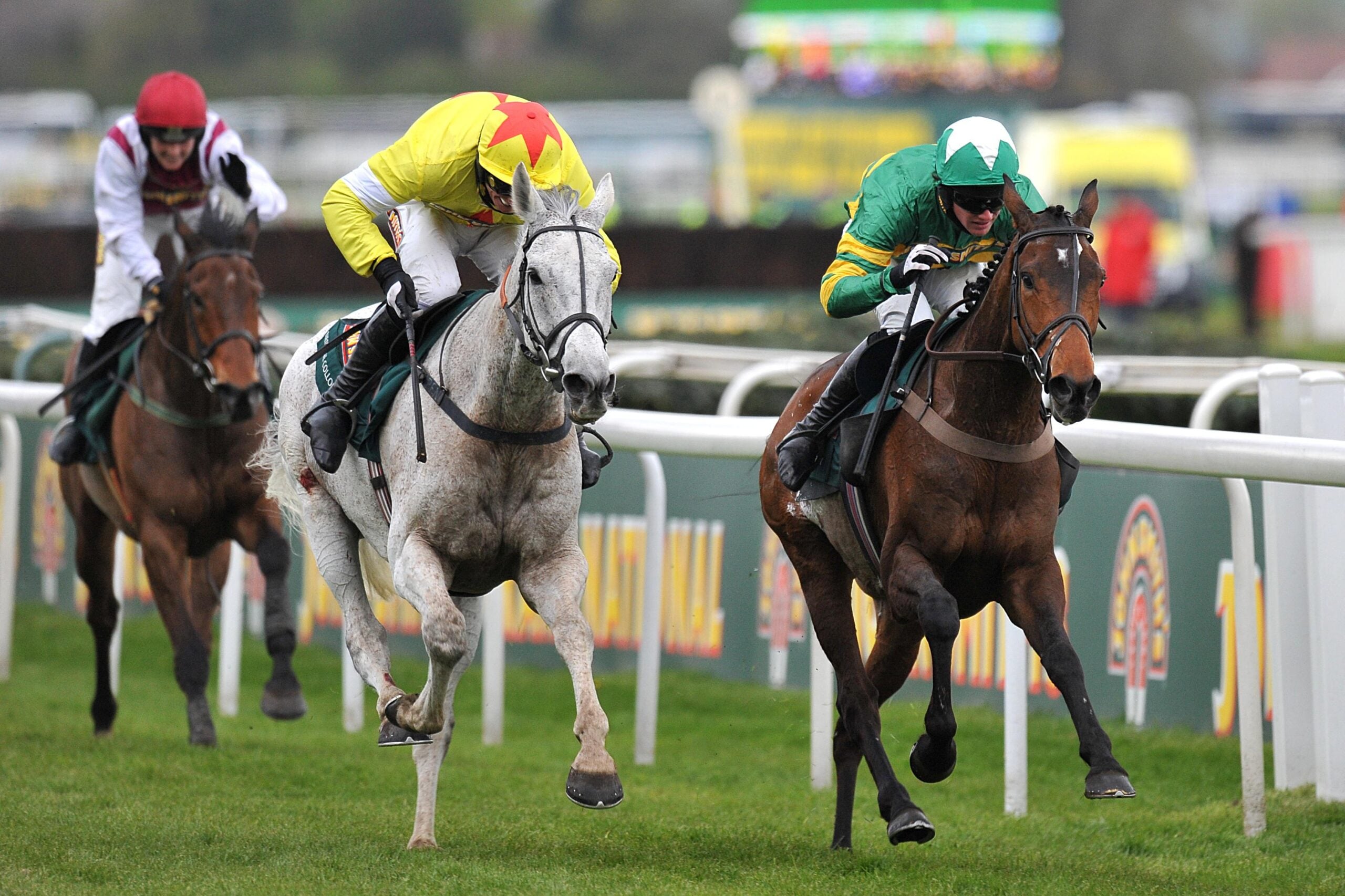 Neptune Collonges ridden by Daryl Jacob (left) races against Sunnyhillboy ridden by Richie McLernon prior to winning the John Smith's Grand National Chase during Grand National Day at Aintree Racecourse, Liverpool.